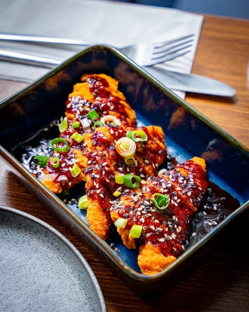 Glazed chicken tenders with spring onion and sesame